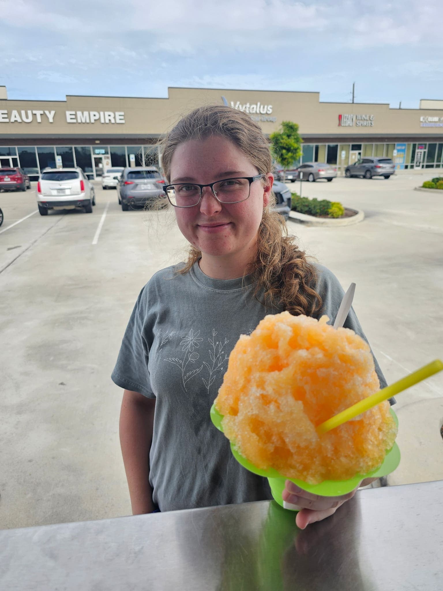 Orange shaved ice customer — Frostbite Shaved Ice N'More